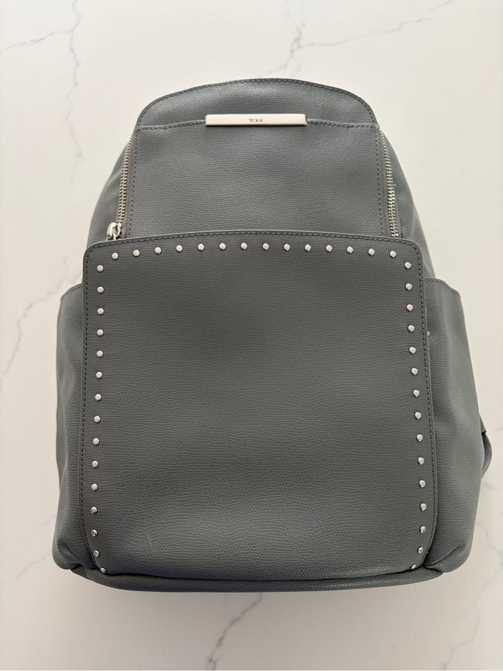 Tumi Women’s Gray Leather Studded Backpack. Large size. 
NWOT. Never used it.